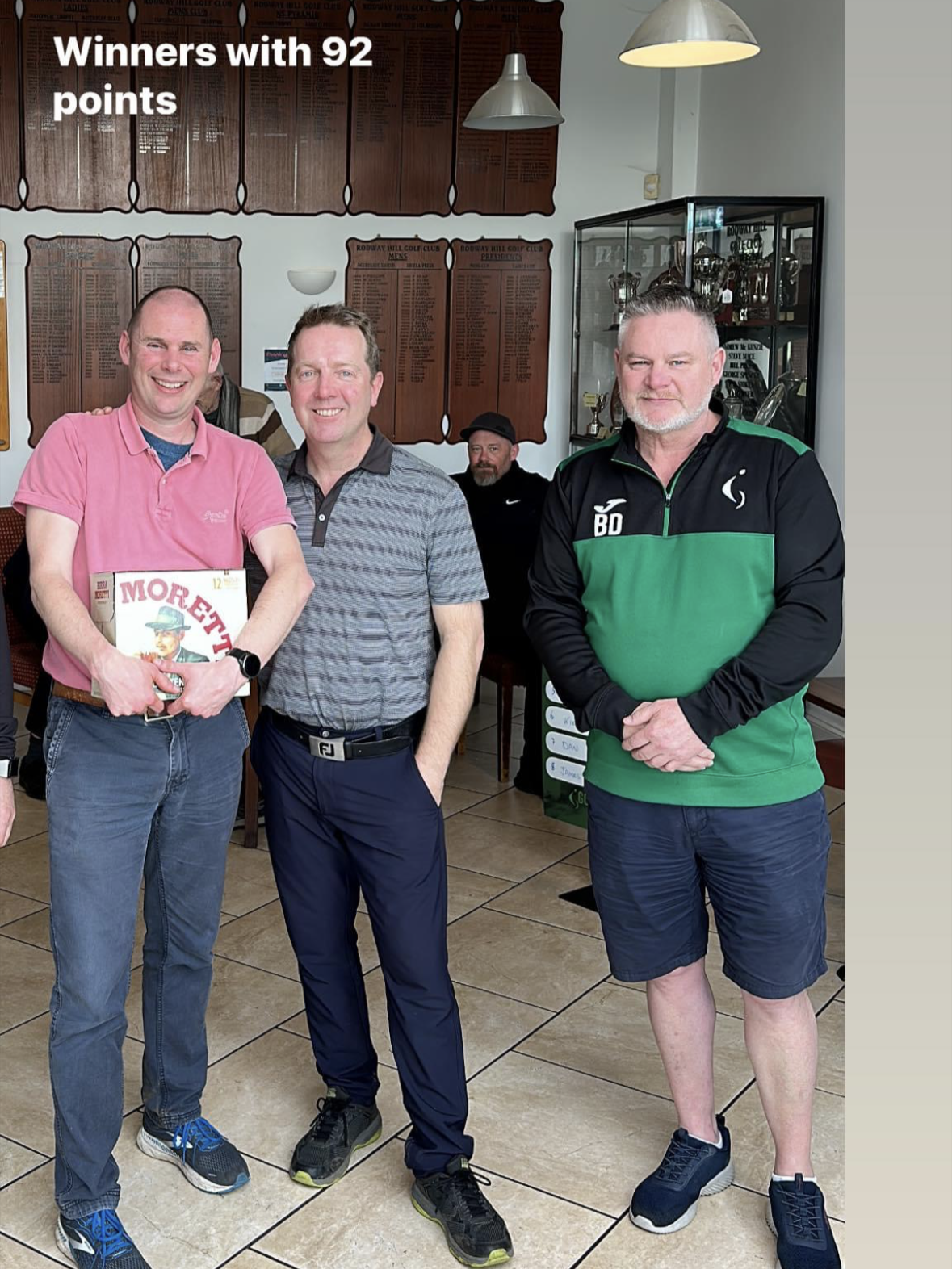 2 players from the winning team accepting their prize, a crate of beer, and a 4-ball voucher for the Marriott Worseley Park